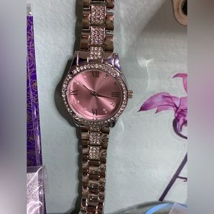 Pink face watch with Roman numerals and rhinestone band watch